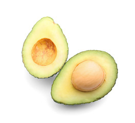 Halves of ripe avocado on white background