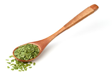 dried tarragon leaves in the wooden spoon, isolated on white