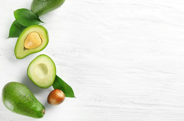 Composition with ripe avocados on white background