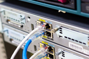 Network switch in rack, network cables connect SFP module port in the Datacenter room, concept Communication technology
