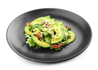Tasty salad with ripe avocado on plate against white background