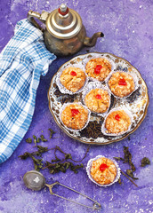 Oriental Algerian sweet cookies( mchawak   named in arabic ), tea cup and pot and mint leaves