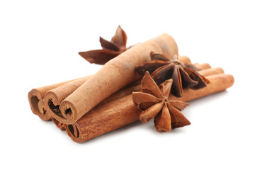 Cinnamon sticks and anise stars on white background