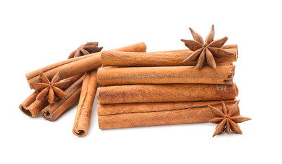Cinnamon sticks and anise stars on white background