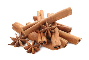 Cinnamon sticks and anise stars on white background