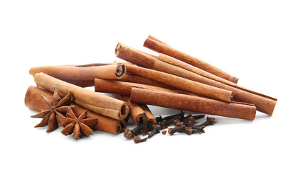 Cinnamon sticks and spices on white background