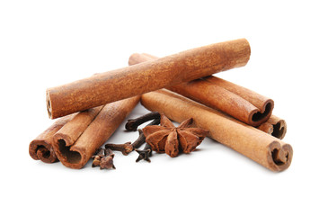 Cinnamon sticks and spices on white background