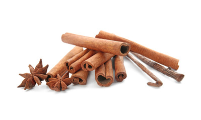 Cinnamon sticks, vanilla pods and anise stars on white background