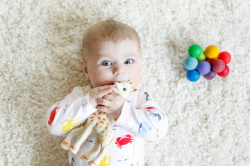 Portrait of cute adorable newborn baby child with toy