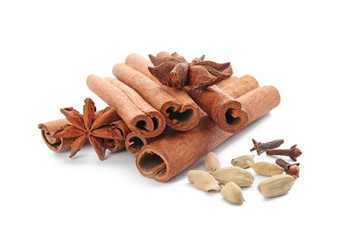 Cinnamon sticks, cardamom, anise and dried cloves on white background