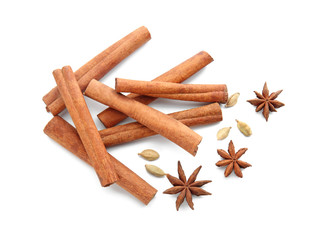 Cinnamon sticks, cardamom and anise stars on white background