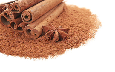 Cinnamon sticks and powder on white background