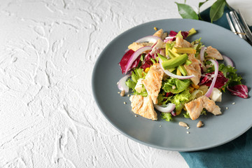 Plate of tasty salad with ripe avocado on table