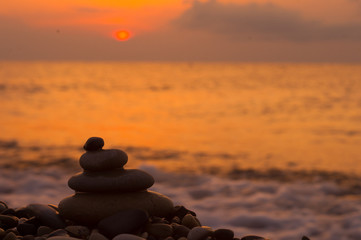 stack of zen stones on pebble beach