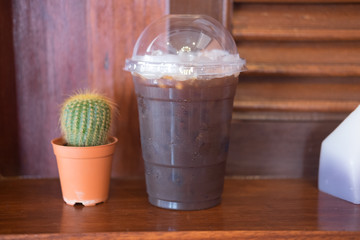 Ice black coffee put near mini cactus