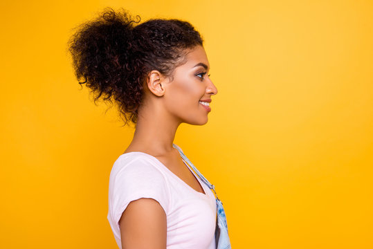 Profile portrait of cute gorgeous girl with beaming smile plump lips in casual outfit isolated on yellow background with copyspace empty place