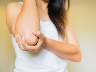 Closeup female's elbow. Arm pain and injury. Health care and medical concept.
