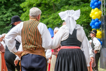 Unrecognizable people perform Swedish folk dance during National day celebration in Norrkoping