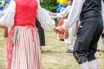 Unrecognizable people perform Swedish folk dance during National day celebration in Norrkoping