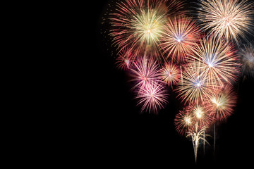 Abstract beautiful colorful fireworks display for celebration on black background with free space...