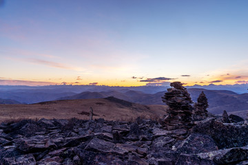 stack of balance stone on top of mountain with sunrsie in tibet