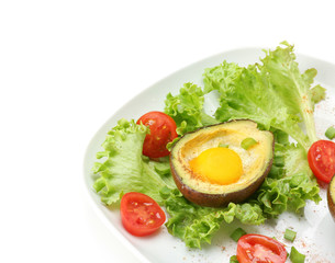 Tasty baked avocado with egg on plate against white background