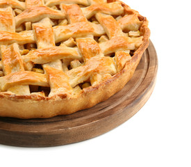 Wooden board with tasty homemade apple pie on white background