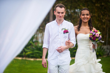 the bride and groom go hand in hand for marriage registration