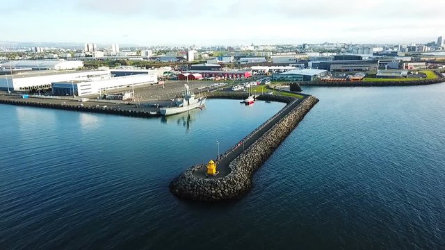 drone approaching the lighthouse and port with ships Reykjavik Iceland. Aerial drone video