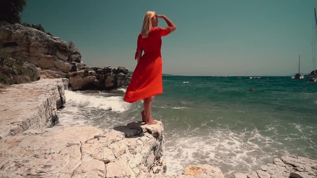 woman in red dress on the beach