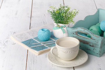 Female leisure, box with knittng yarn on white table