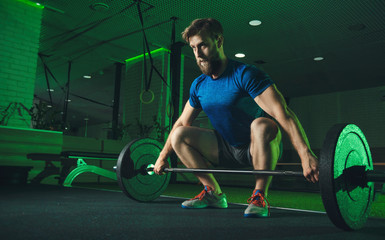 a man in the gym pushes the bar