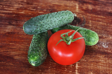 Tomato and cucumber on a wooden table