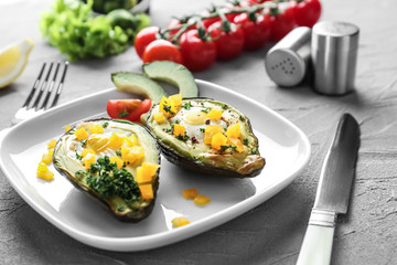 Baked avocado with eggs on plate