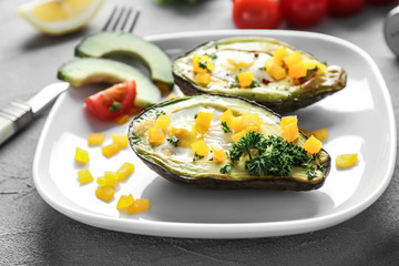 Baked avocado with eggs on plate