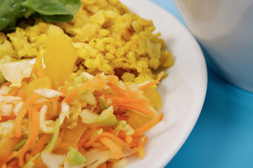 Baked Bulgar with cauliflower and vegetable salad on a blue
