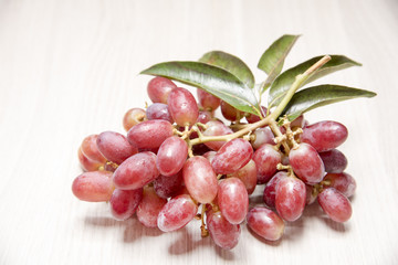 Red grapes on wooden floor