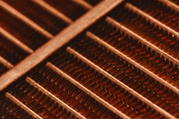 Lattice texture of old rusty radiator with copy space. Background of automotive radiator close-up. Abstract artwork with auto part in macro.