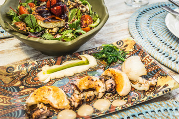Healthy salad and cuttlefish with garlic and herbs