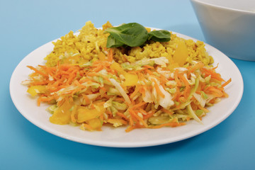 Baked Bulgar with cauliflower and vegetable salad on a blue