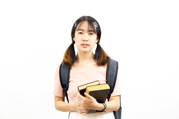 Smiling happy and casual Asian female college students holding pile of books with bag isolated over white background.