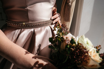Bride in a wedding dress and with a bouquet in hands