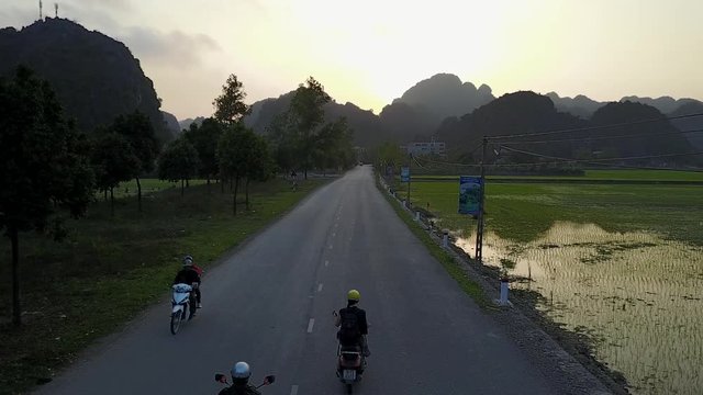 Motorbike Riders on Rural Road in Vietnam