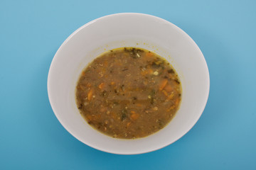 Lentil soup with carrot on a blue