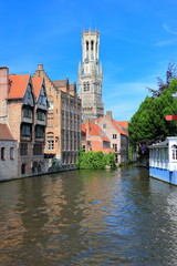 Fototapeta na wymiar The Rozenhoedkaai (canal) in Bruges with the belfry in the background. Belgium, Europe.