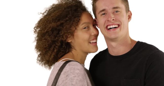 Millennial couple pose for a portrait on white background with copyspace, Happy Caucasian male and African female smile at camera in studio with copy space, 4k