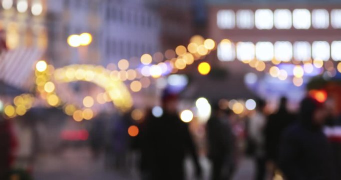 Night City Boke Lights. Festive Illumination, Natural Defocused Blurred Bokeh Background Effect Of Traditional Christmas Trading Houses In Winter Evening Night In Festive Lighting