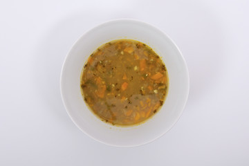Lentil soup with carrot on a white