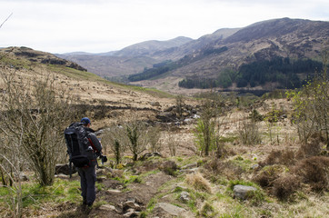 Fototapeta na wymiar Hiker Wandering Across Countryside 