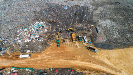 A lot of waste is disposed of in the waste disposal pits. Loaders is working on a mountain garbage....